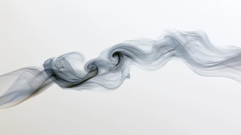 Thin wisps of pale gray smoke swirling horizontally across a white background
