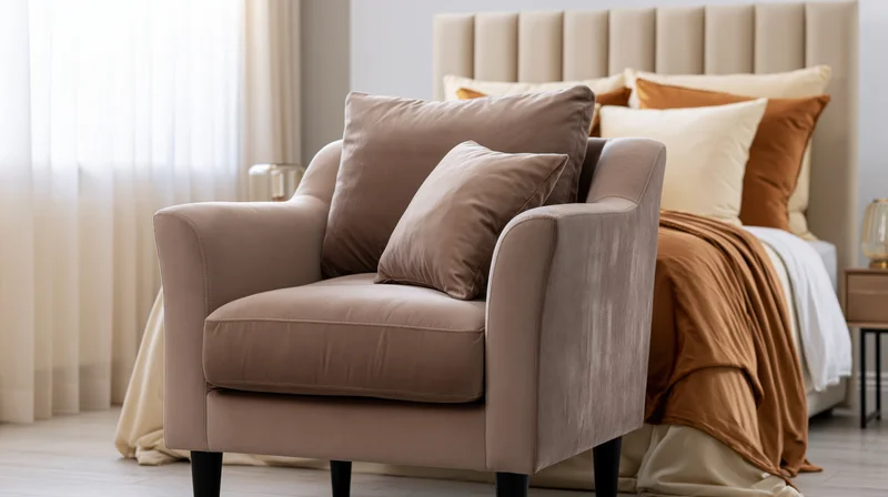 Taupe velvet armchair with cushions in a bedroom setting