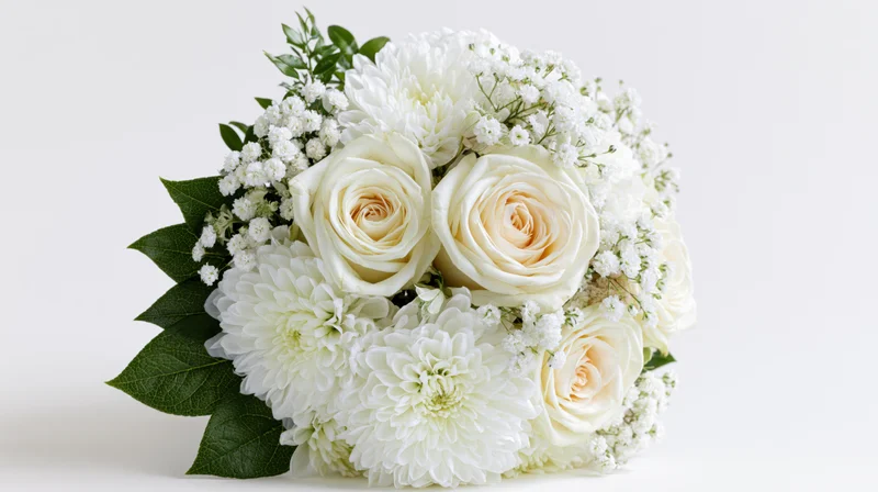 White rose and chrysanthemum bouquet with baby's breath and green leaves on white background