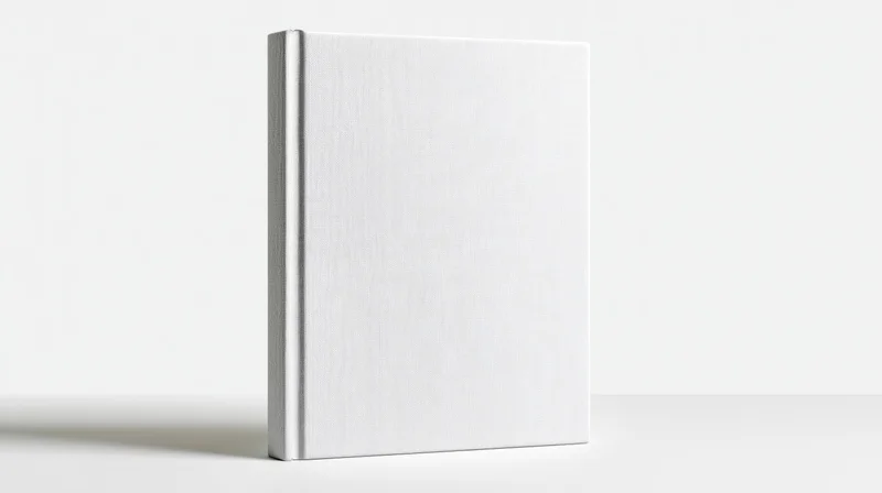 Blank white hardcover book standing upright centered on white surface