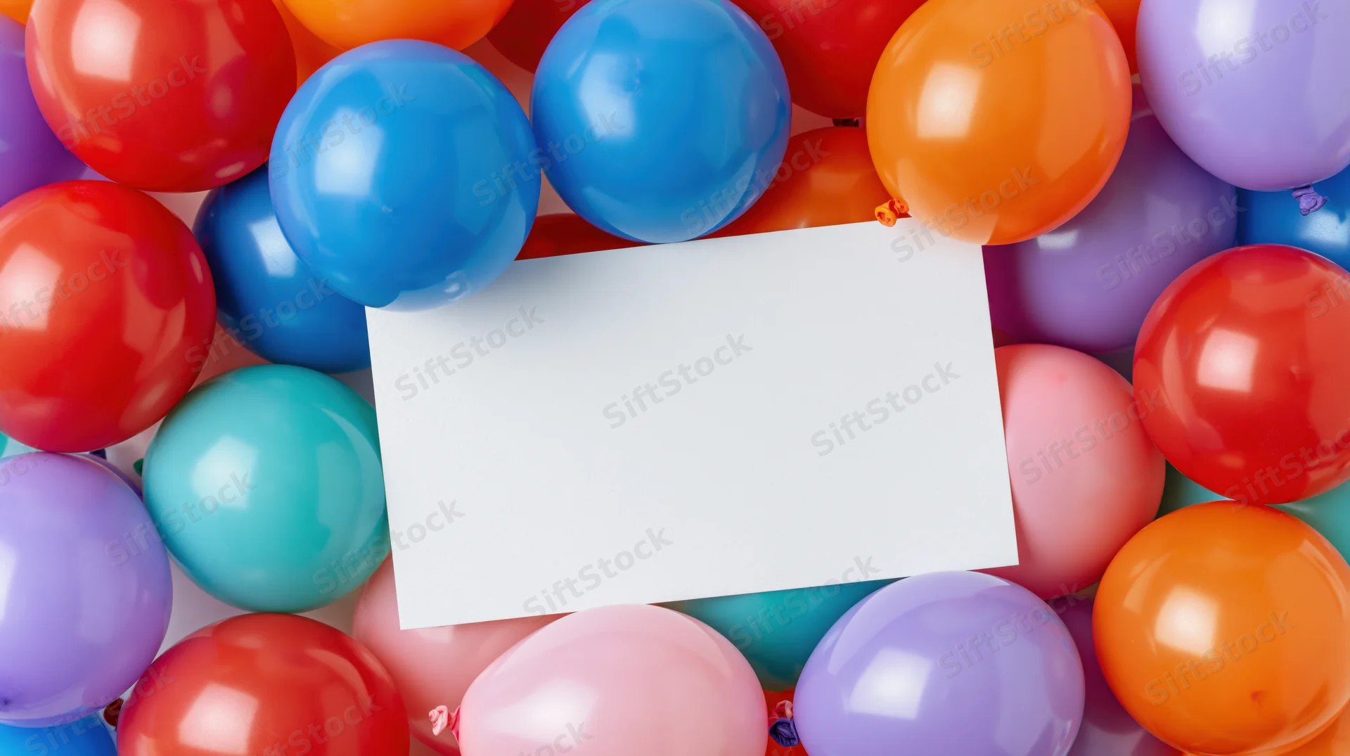 Blank white card surrounded by colorful balloons for party decoration