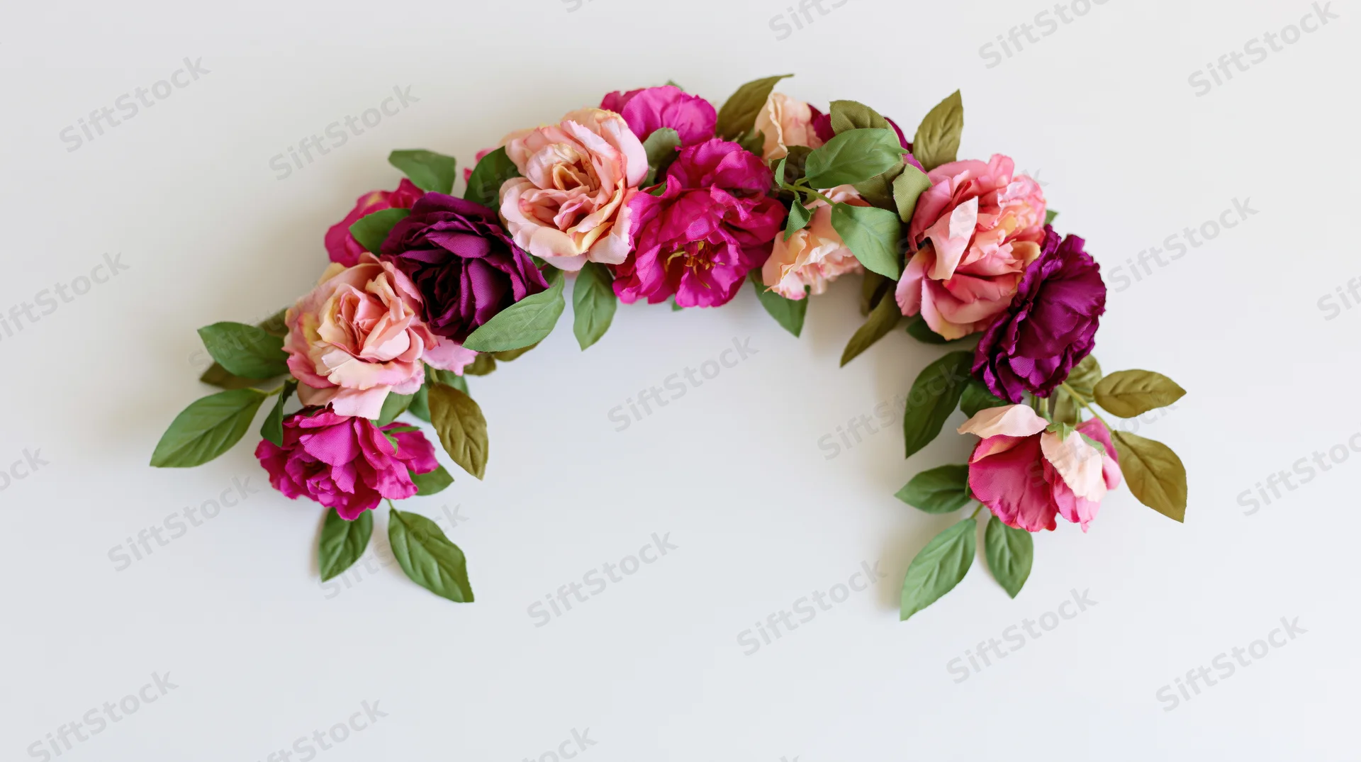 Floral garland arranged in an arch shape with pink and purple roses and green leaves on a white background