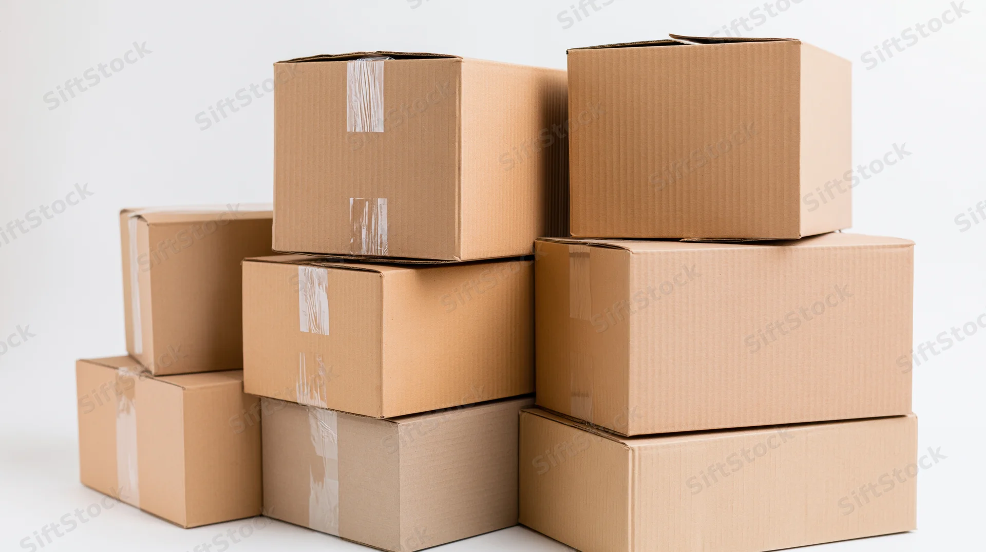 Stacked cardboard boxes arranged in a pile on a white surface