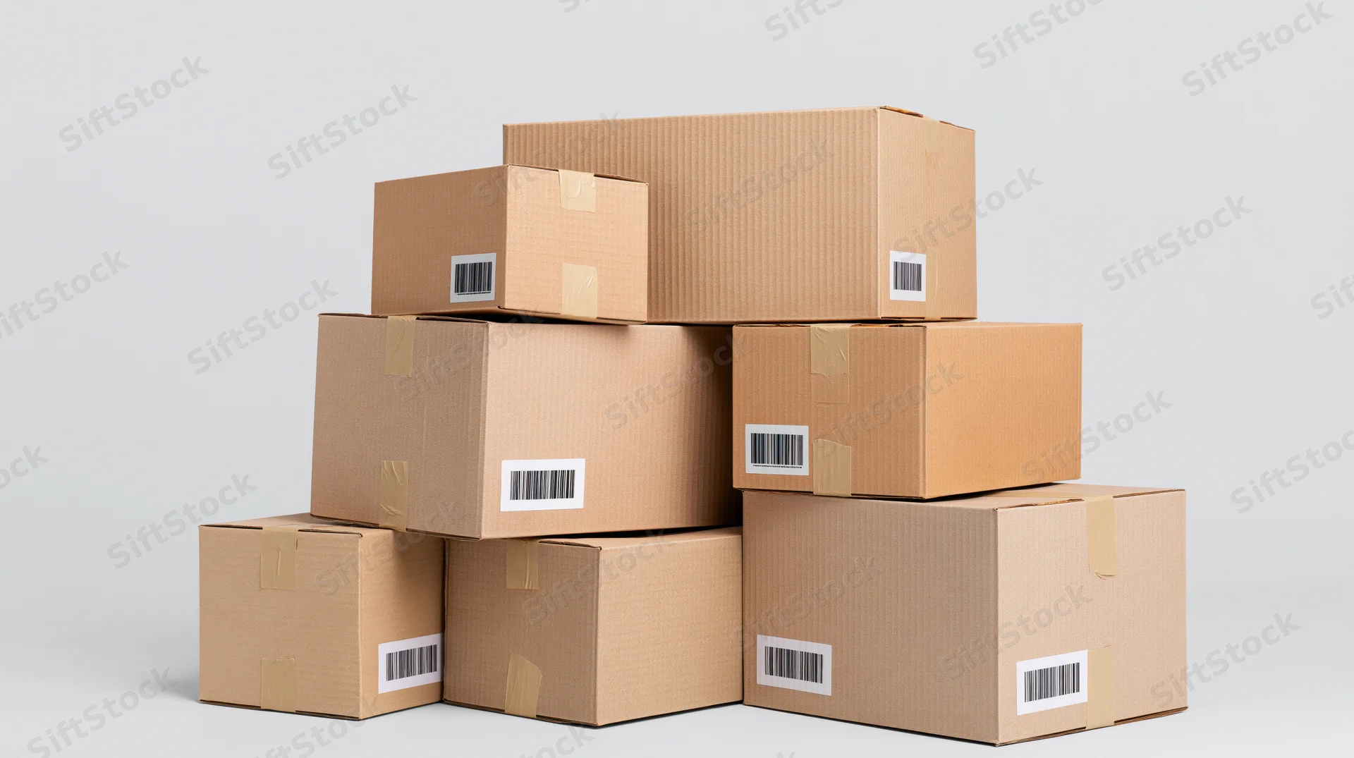 Stacked cardboard shipping boxes of various sizes on a plain background