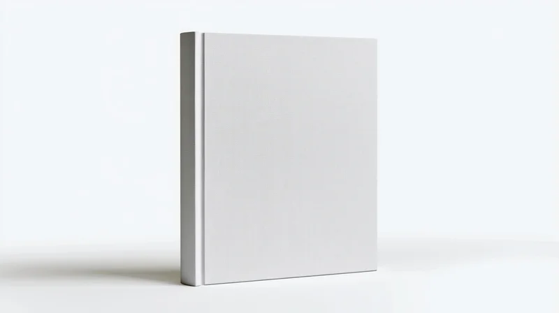 Plain white hardcover book standing upright on white surface with blank cover for design mockup