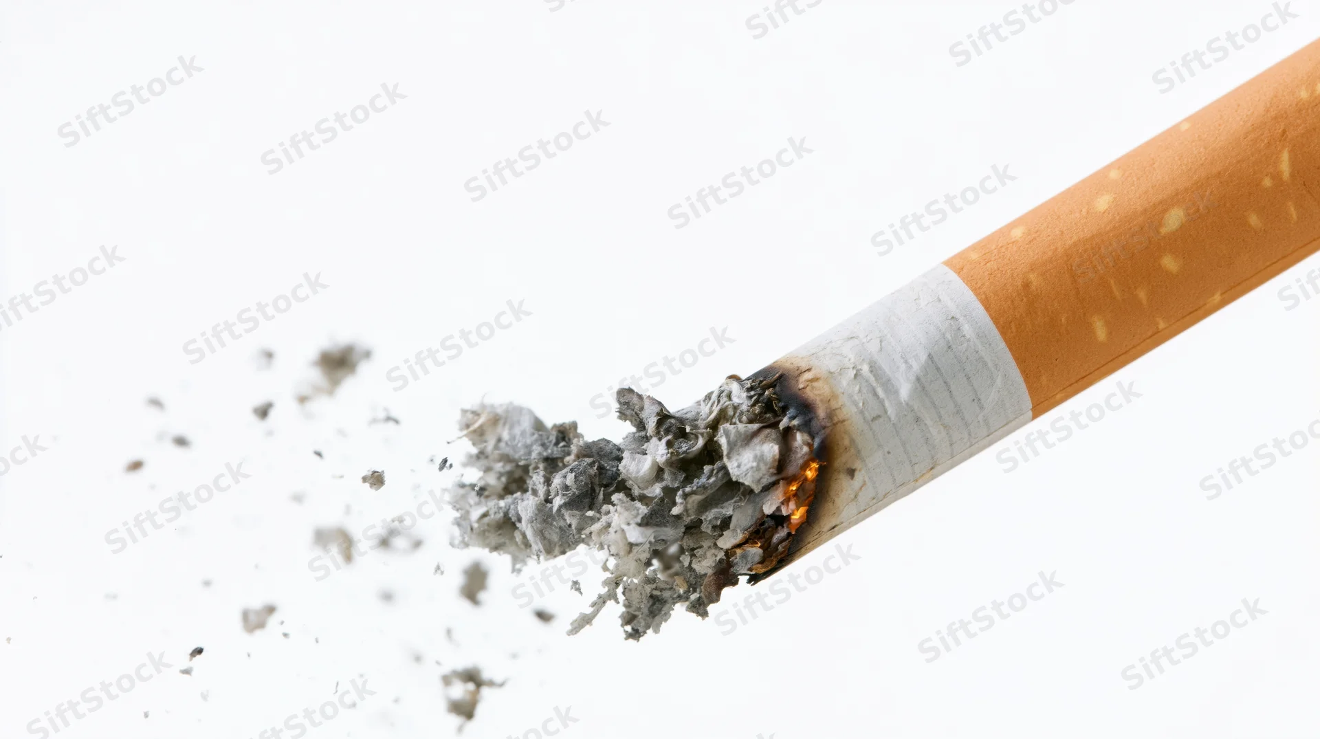 Lit cigarette with burning tip and ash falling against white background