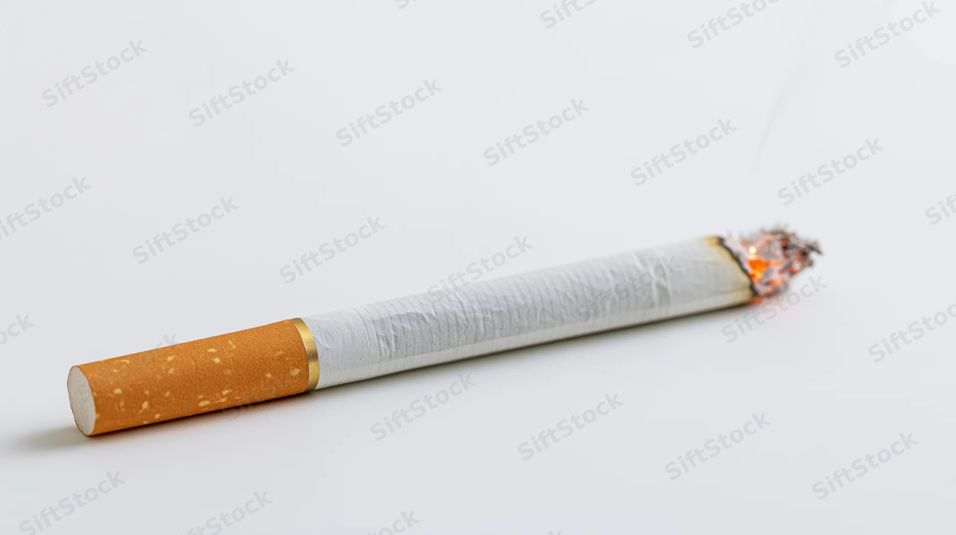 Lit cigarette with glowing ember and thin smoke on white background