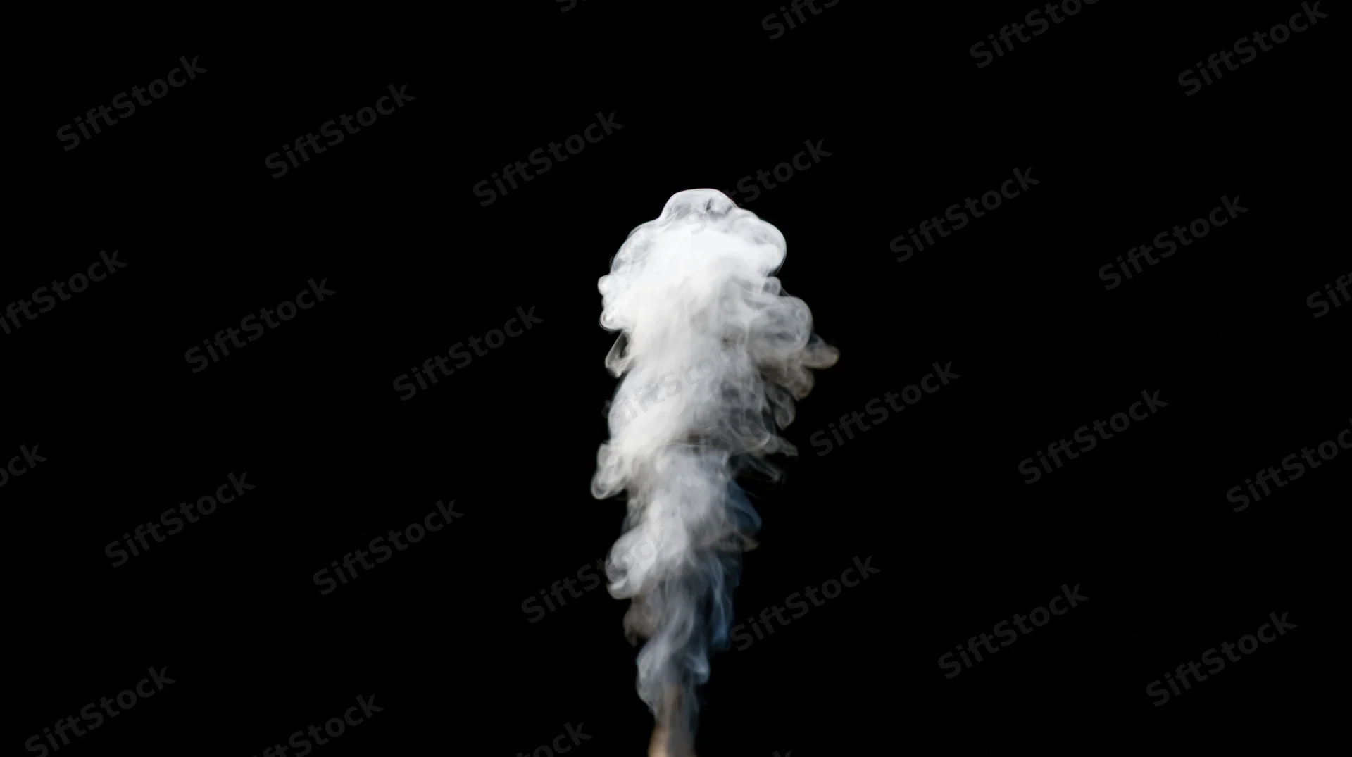 Rising plume of white smoke drifting upward against black background