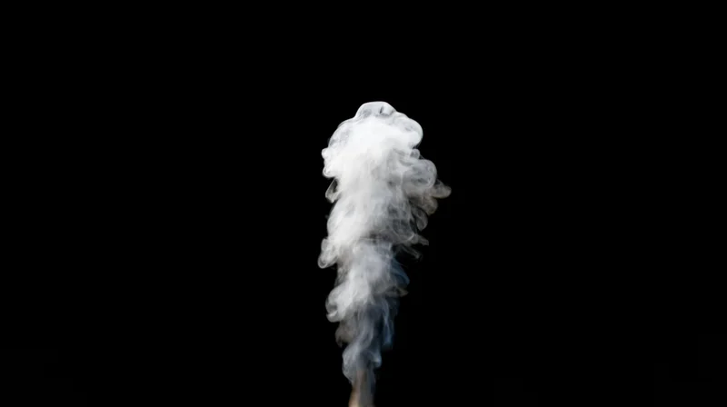 Rising plume of white smoke drifting upward against black background