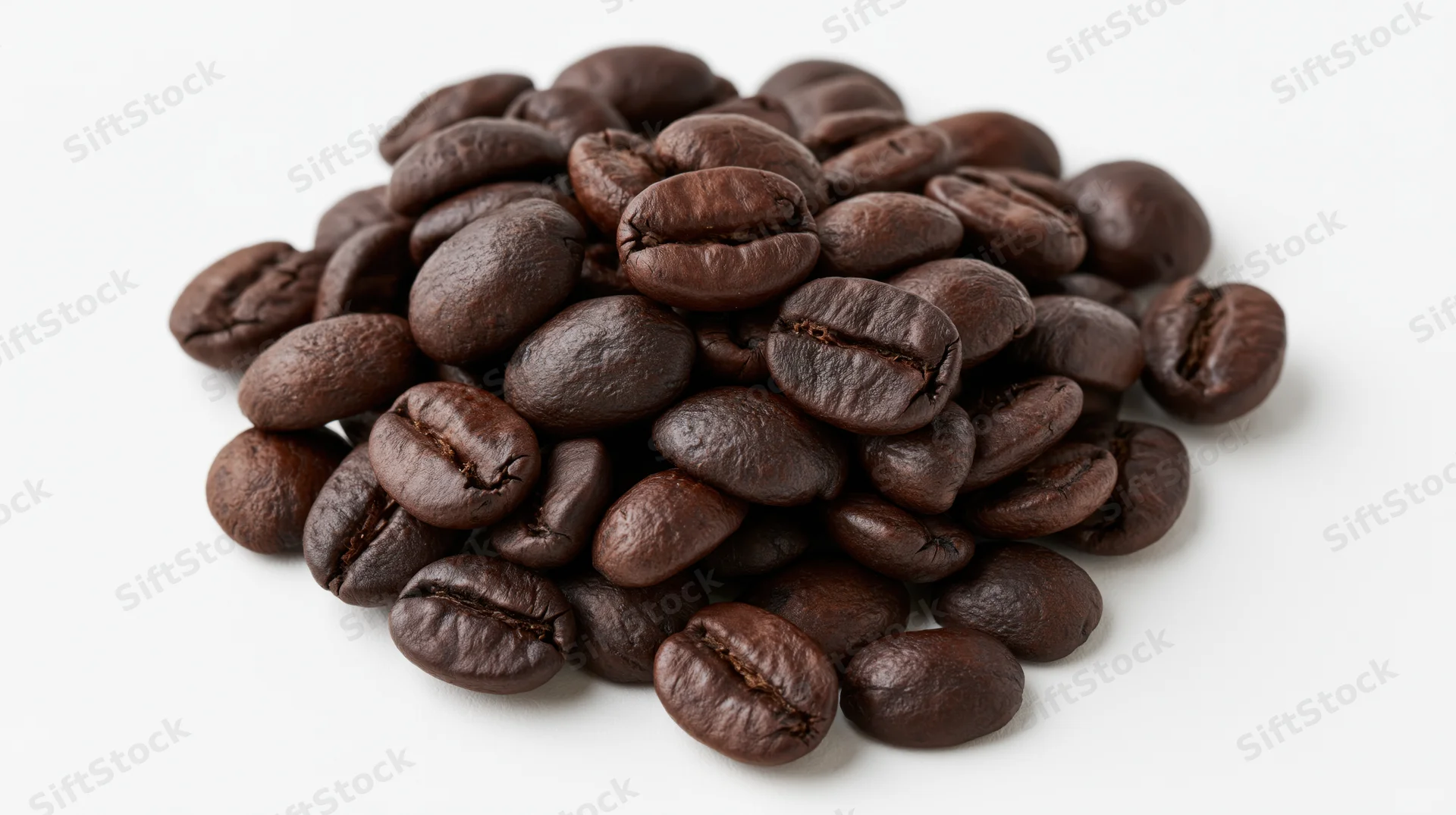 Small loose pile of dark-roasted coffee beans heaped on white background