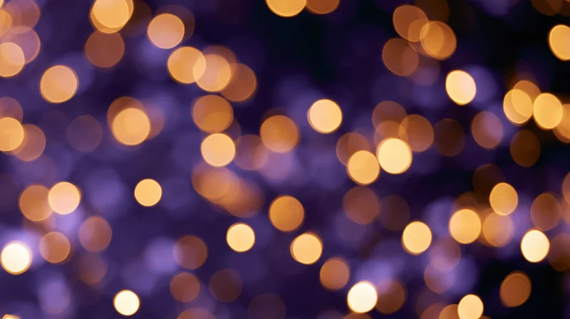 Abstract bokeh background with scattered golden lights on purple blur