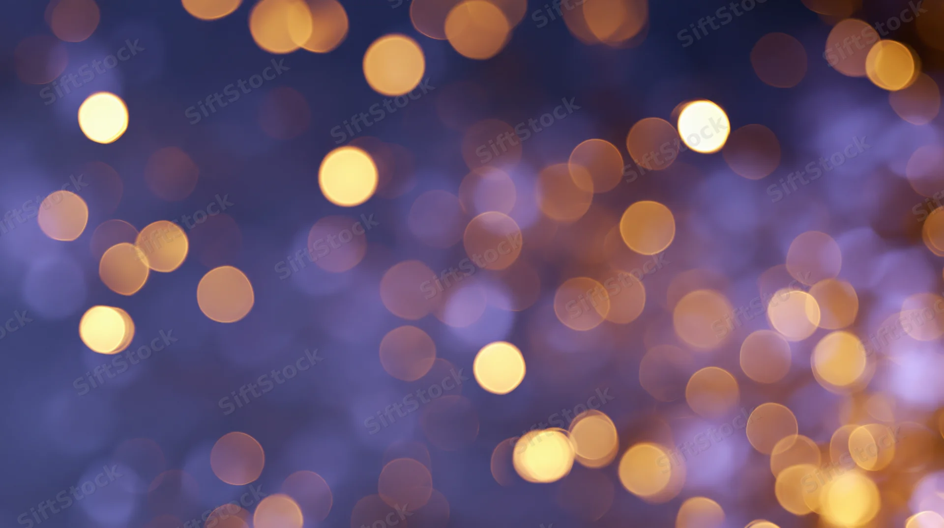 Abstract bokeh background with scattered golden lights on a dark blue gradient