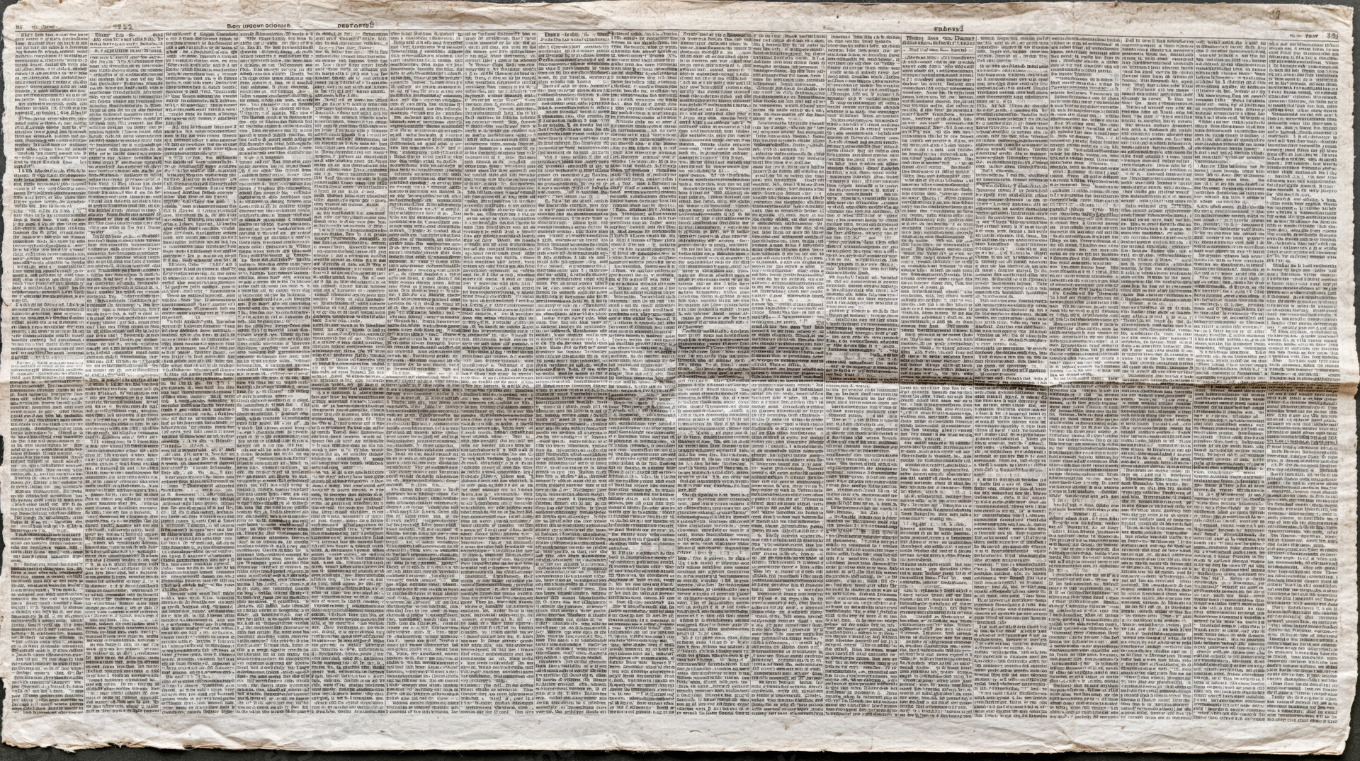 Aged newspaper page with dense columns of text filling the frame