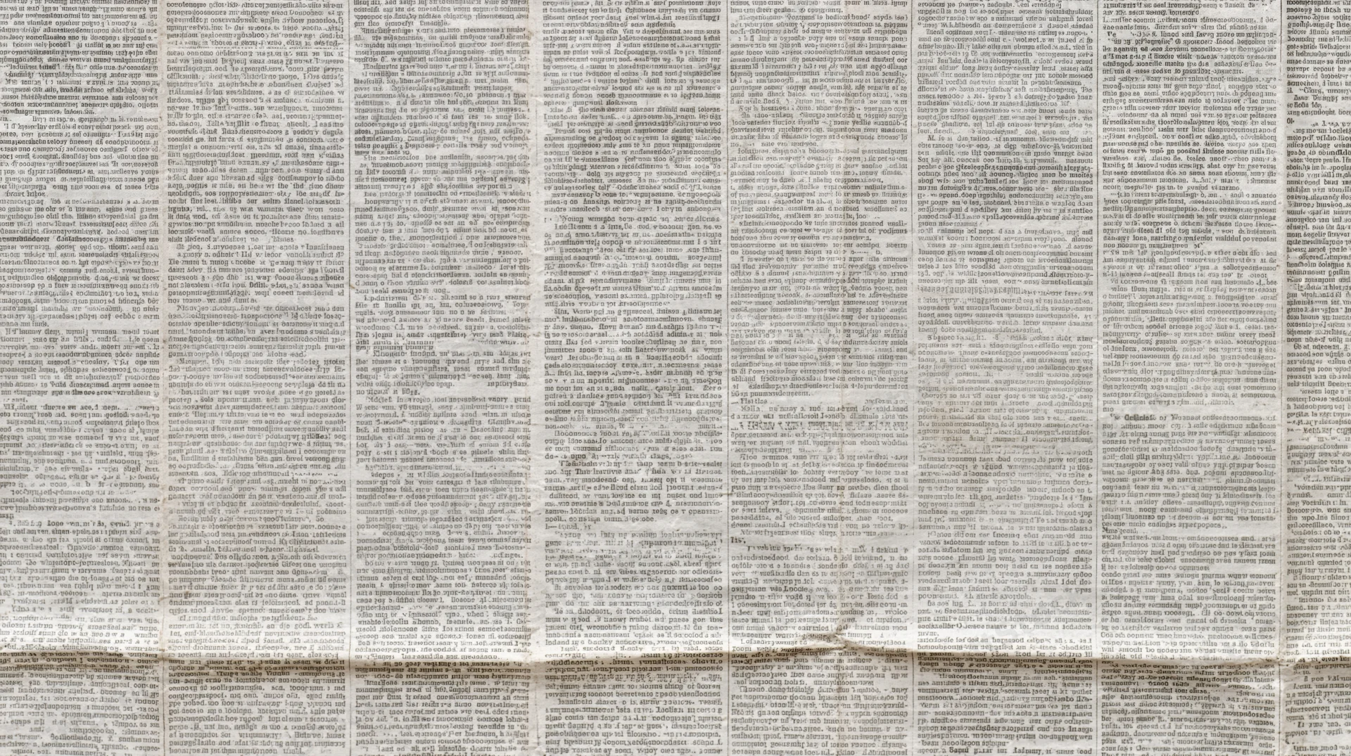 Aged newspaper texture filling the frame with multiple columns of text