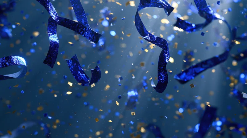 Blue and gold metallic confetti and ribbon streamers falling in celebration