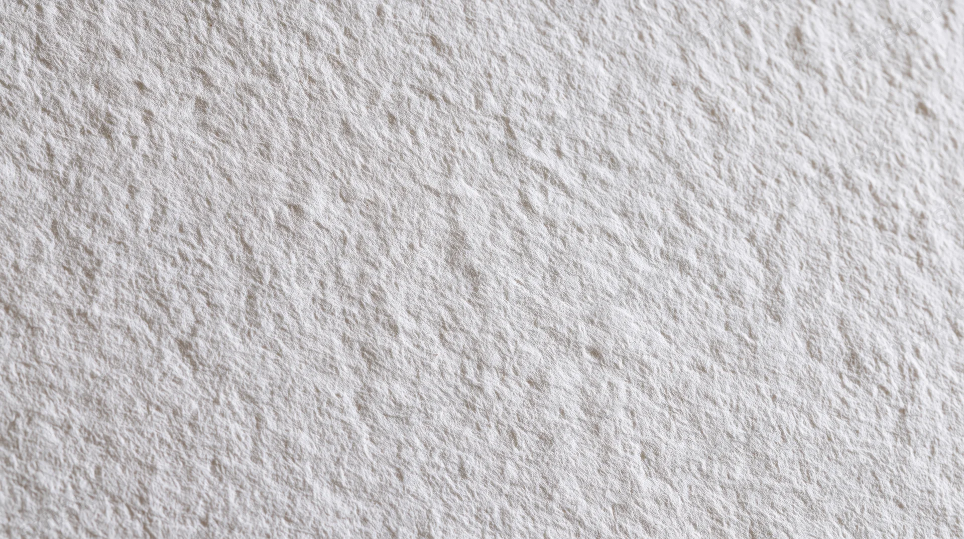 Close-up of a plain white paper sheet with textured surface filling the frame
