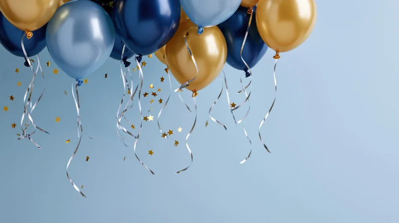 Cluster of blue and gold metallic balloons with silver ribbons and star confetti floating against a light blue background