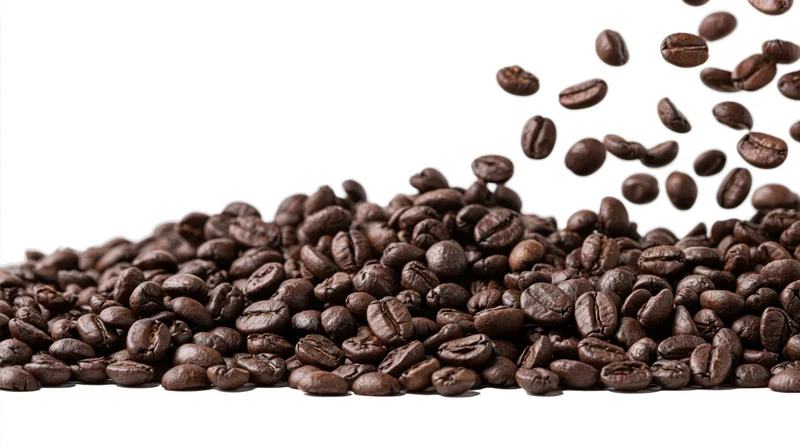 Dark roasted coffee beans falling and scattered in a pile on white background