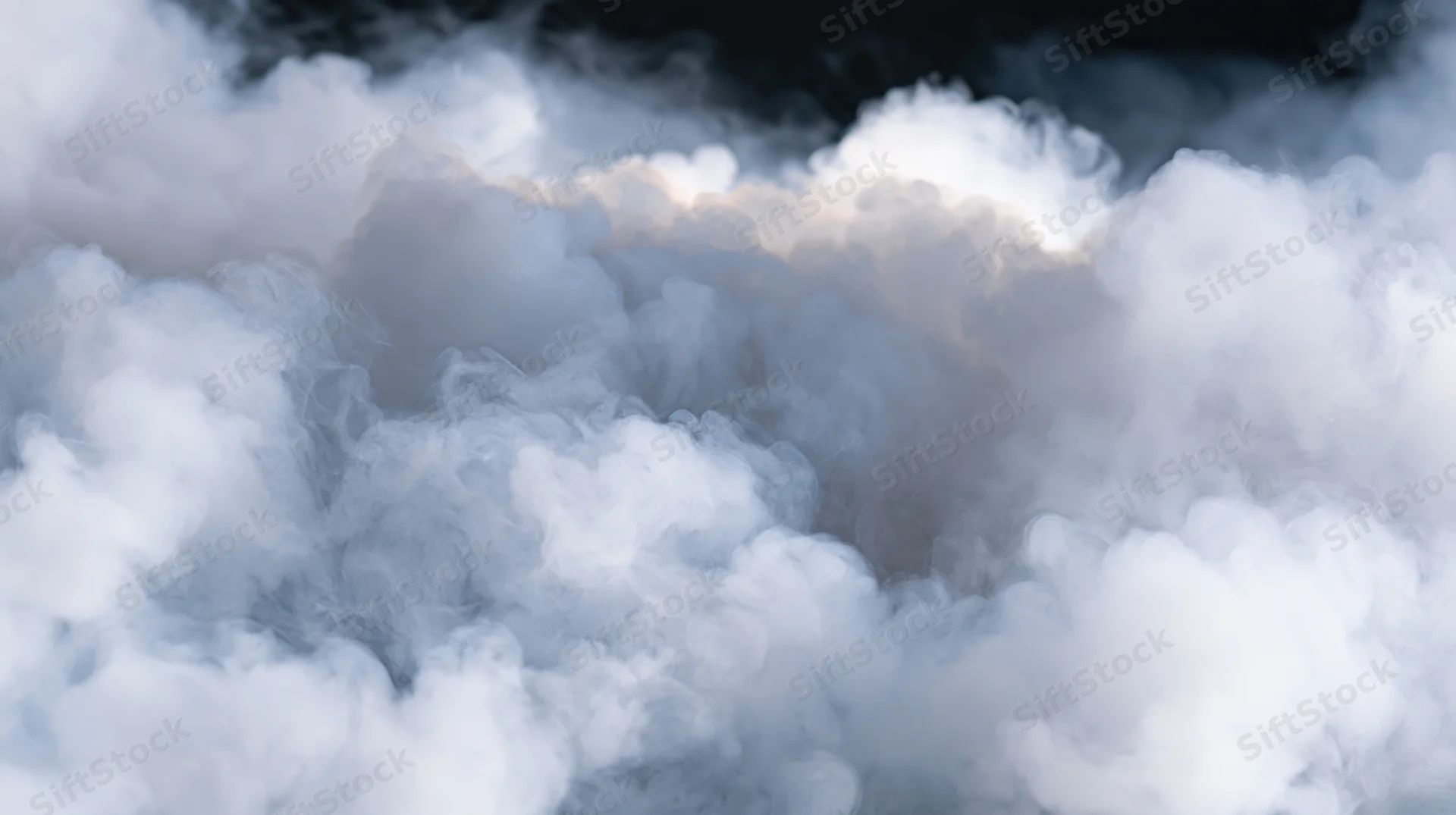 Dense white smoke billowing and rolling against a dark background