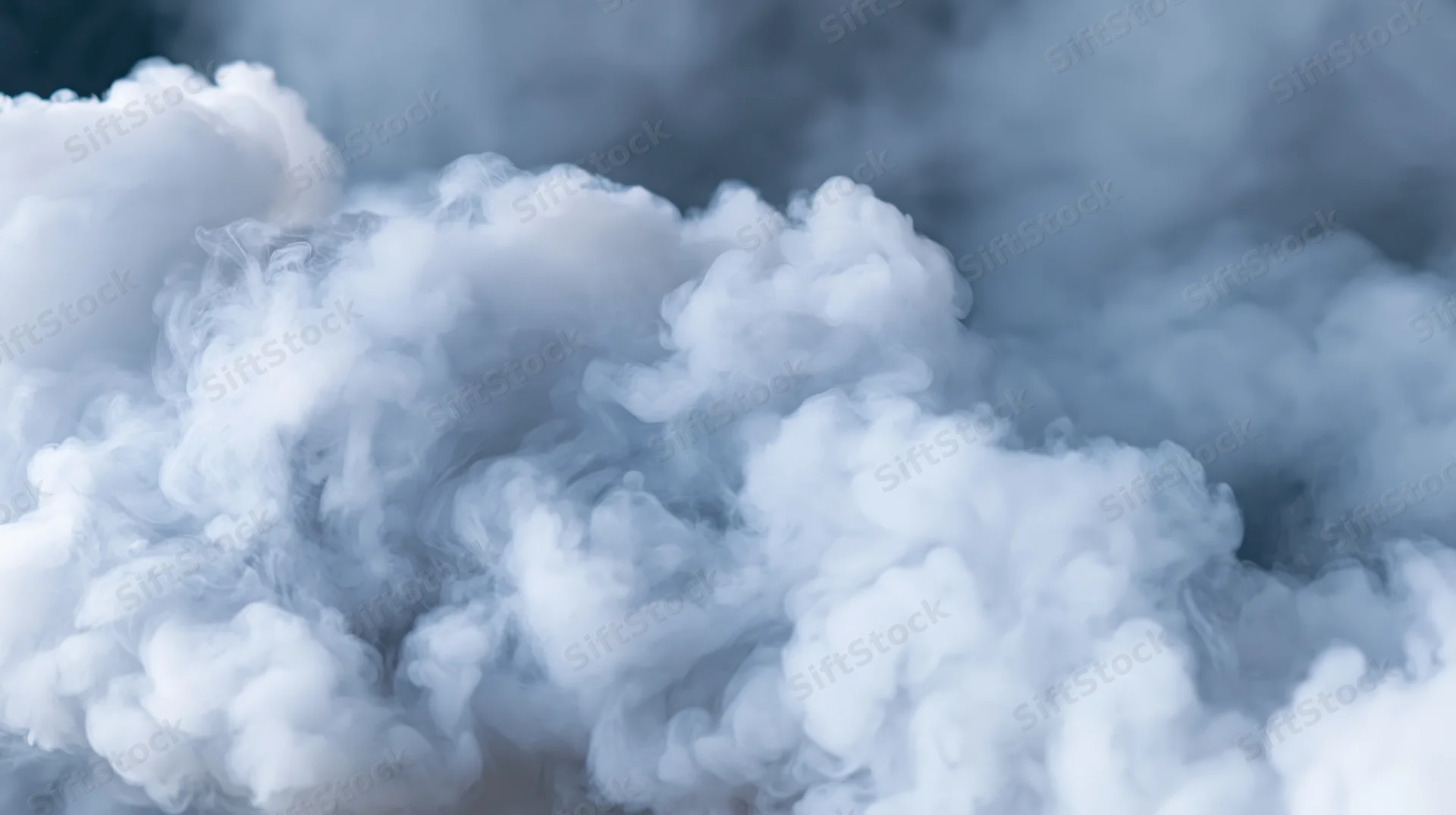 Dense white smoke billowing and rolling against a dark background