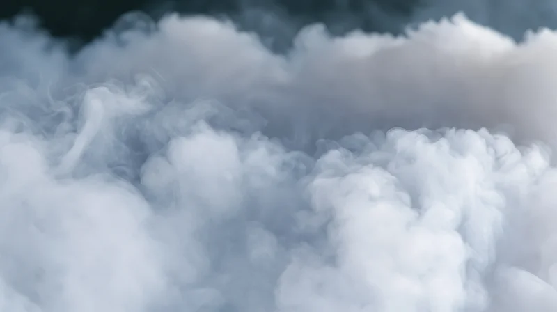 Dense white smoke billowing and rolling against a dark background