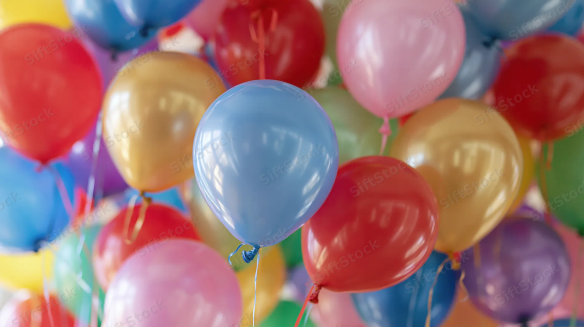 Cluster of colorful helium balloons floating together in a festive arrangement