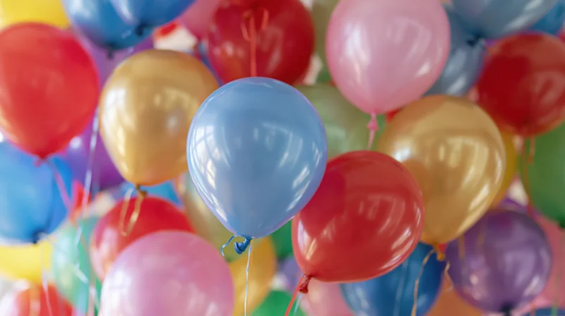 Cluster of colorful helium balloons floating together in a festive arrangement