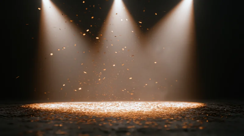 Stage floor illuminated by three converging spotlights with floating golden particles