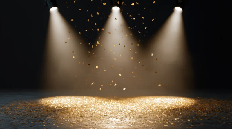 Three spotlights illuminating a stage floor with falling golden confetti