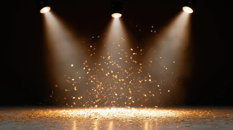 Stage floor illuminated by three spotlights with golden confetti falling in beams of light