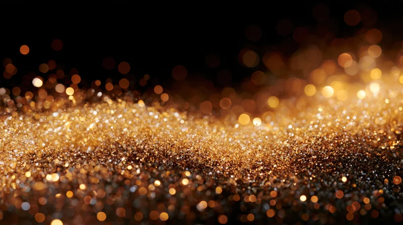 Golden glitter particles shimmering across a dark background with bokeh lights