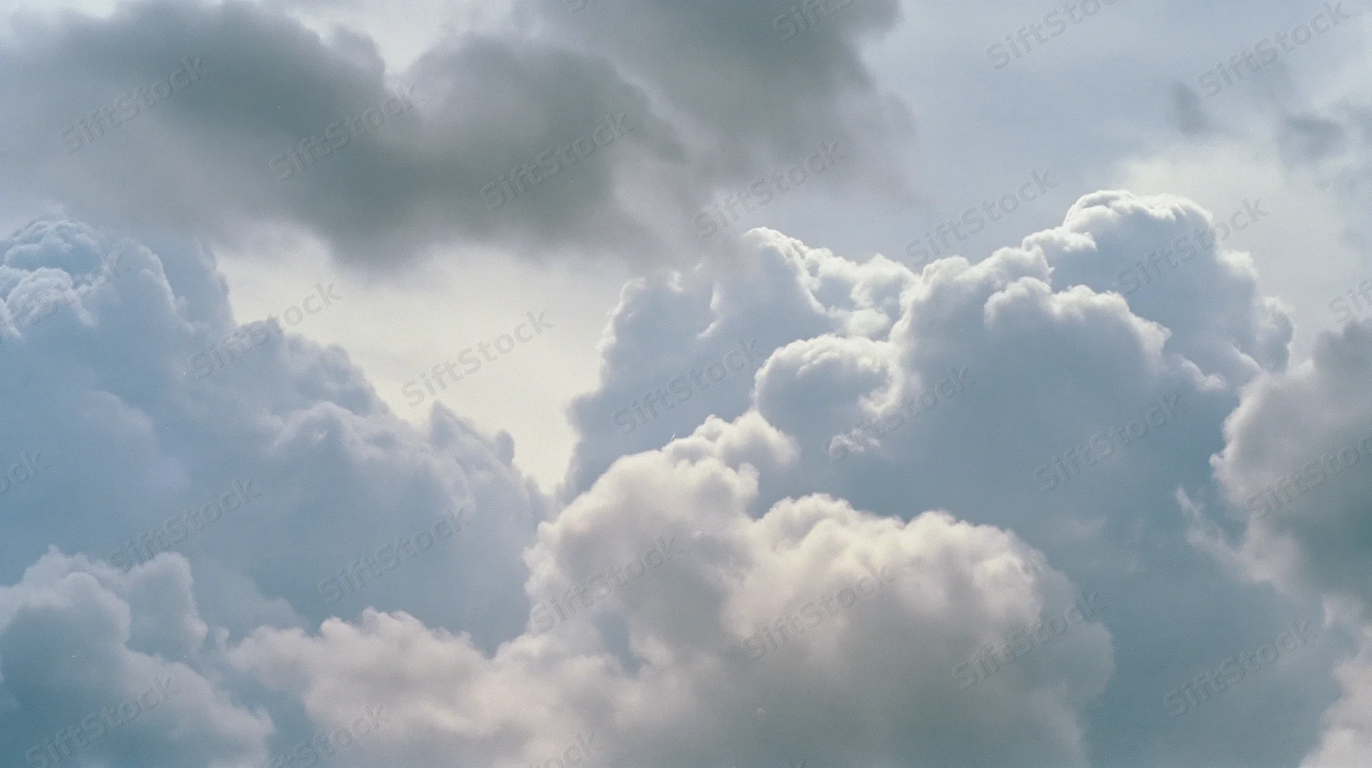 Large cumulus clouds billowing across the sky in daylight