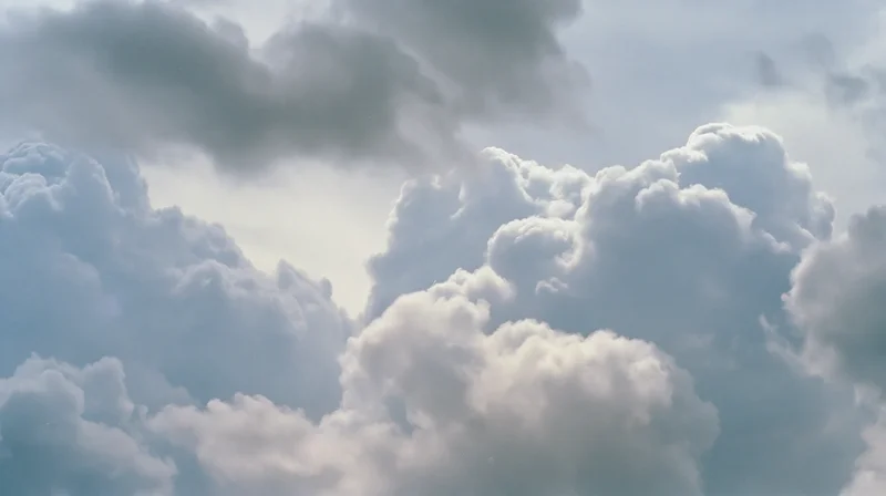 Large cumulus clouds billowing across the sky in daylight