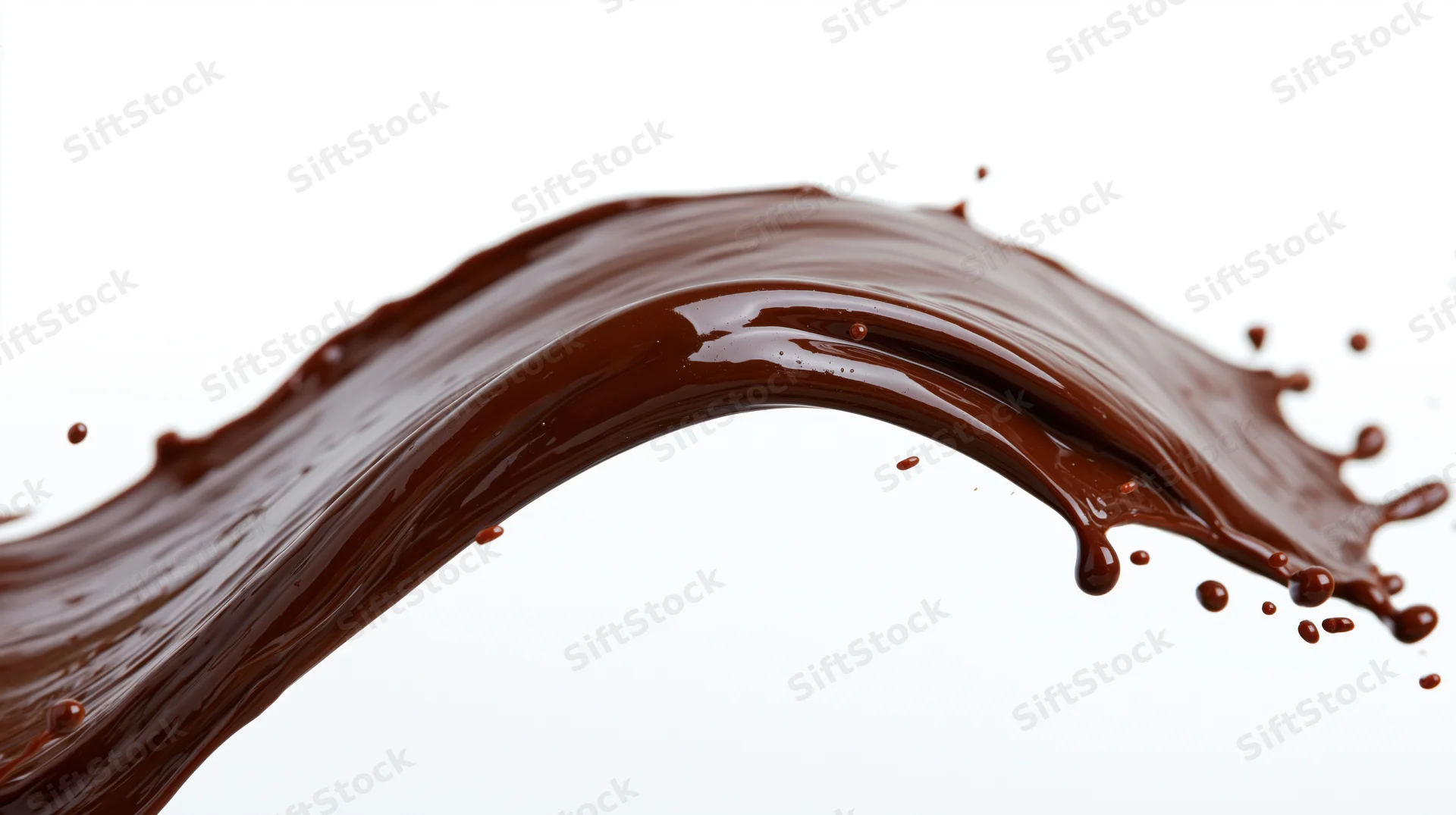 Dark chocolate liquid splashing in mid-air forming an arc against white background