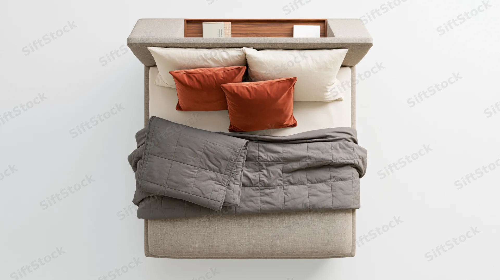 Overhead view of a modern upholstered double bed with gray quilt and orange pillows in a minimalist bedroom setting