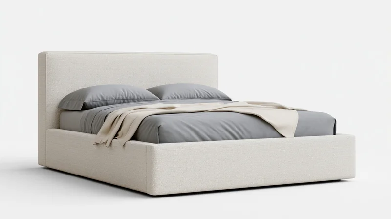 Modern upholstered platform bed with gray bedding and beige throw on white background