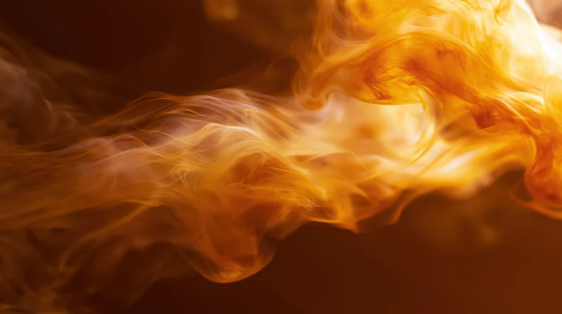 Swirling orange and amber smoke wisps against a dark background