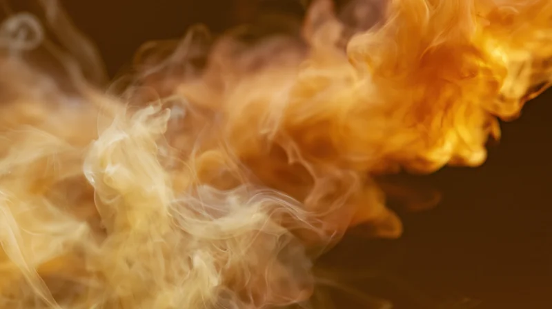 Swirling orange and amber smoke wisps rising against a dark background