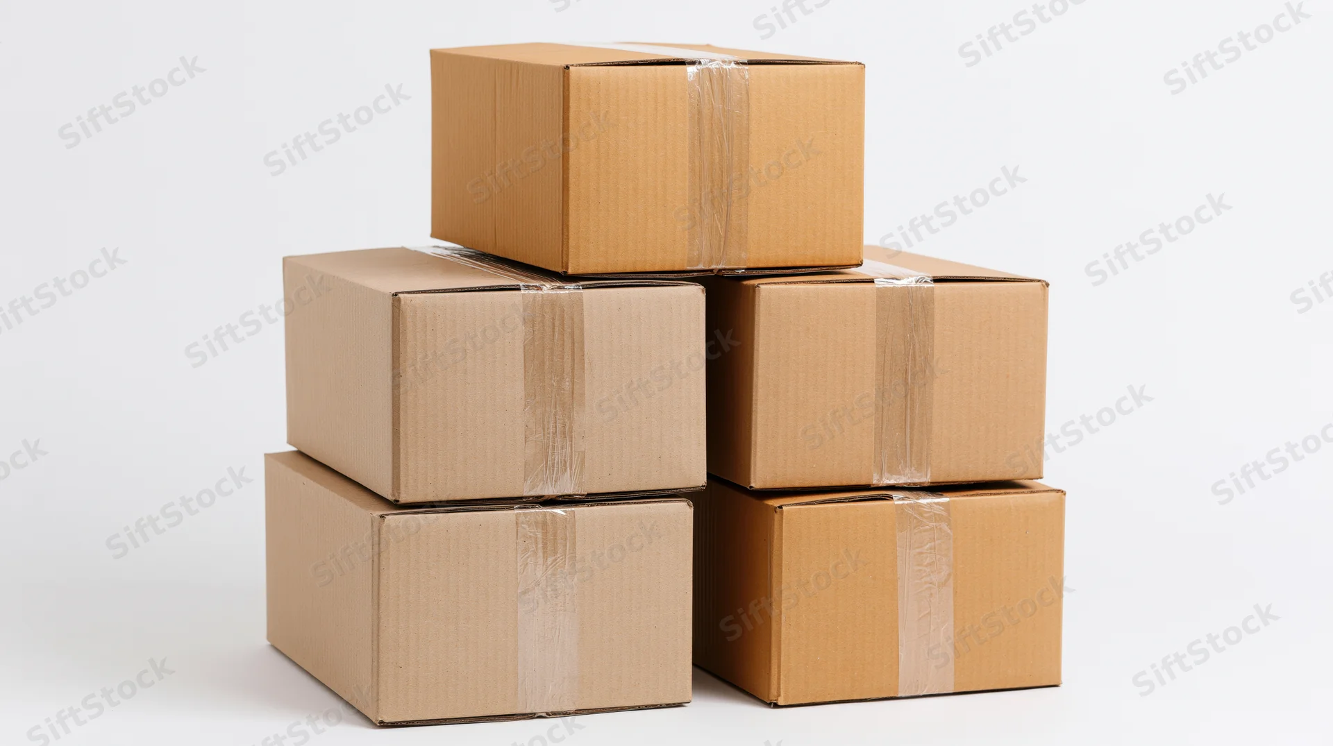 Stacked cardboard boxes arranged in pyramid formation on white background