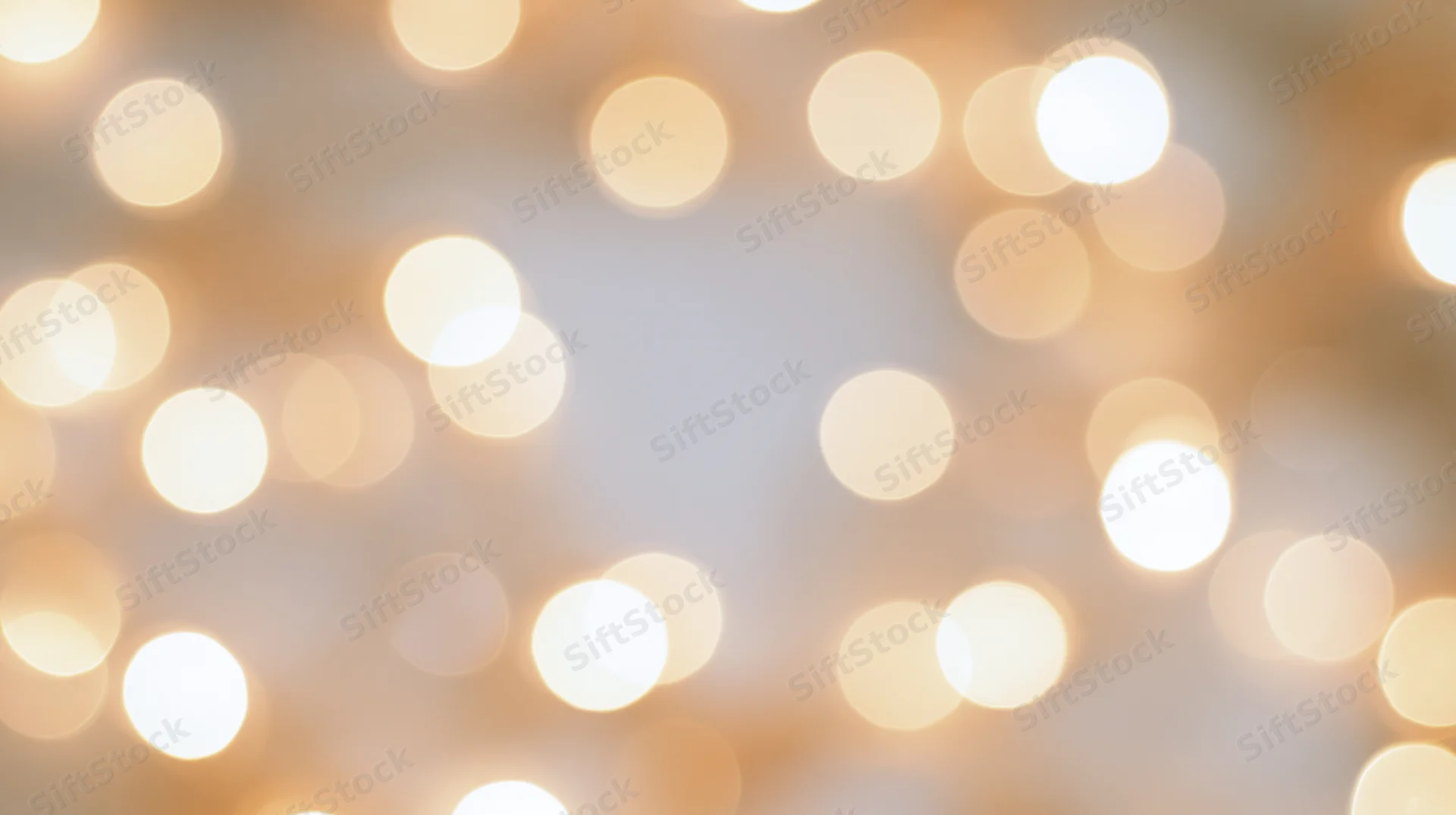 Soft out-of-focus bokeh lights with warm golden glow as a festive background