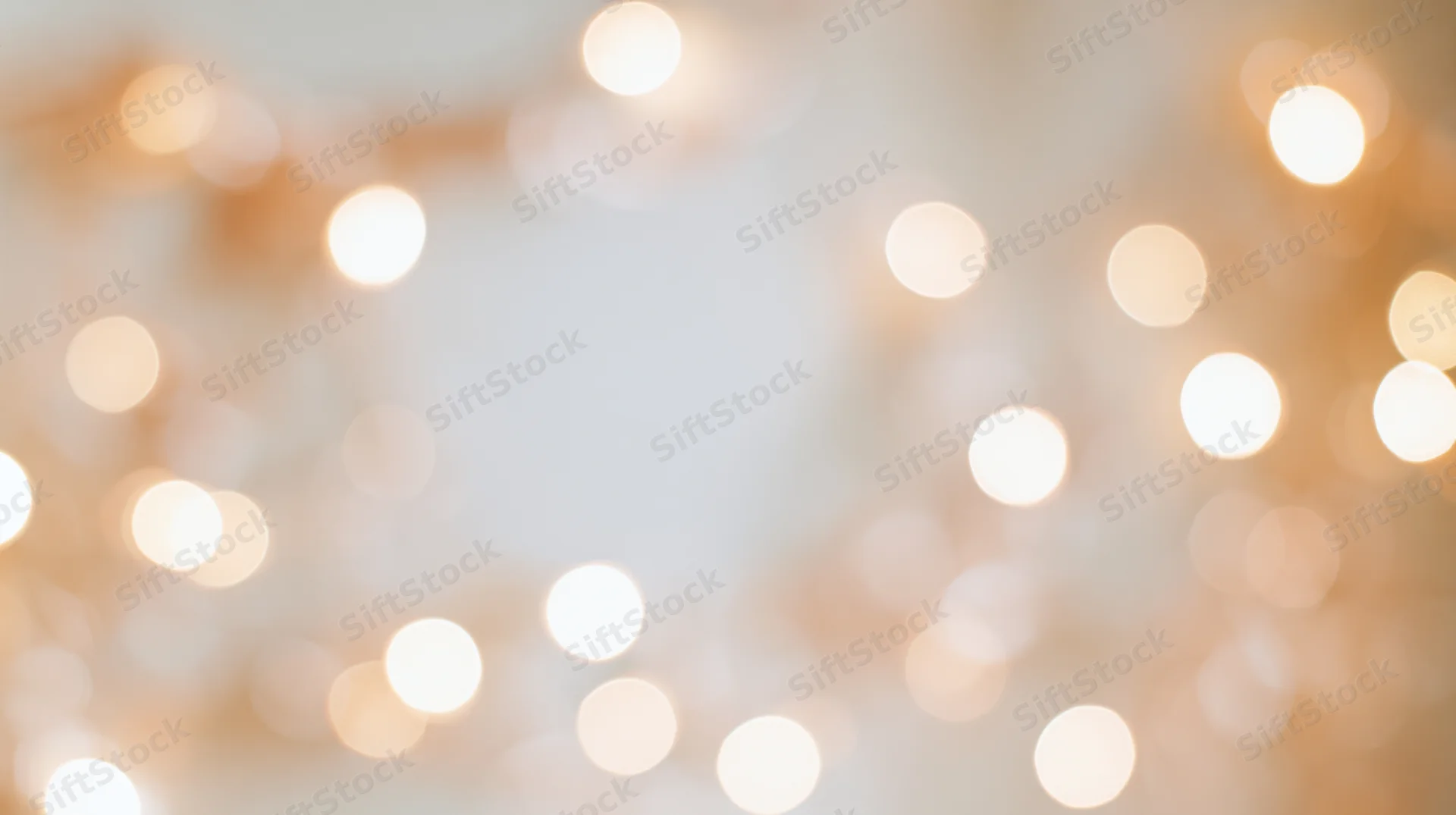 Soft out-of-focus bokeh lights in warm glow forming a festive background with copyspace