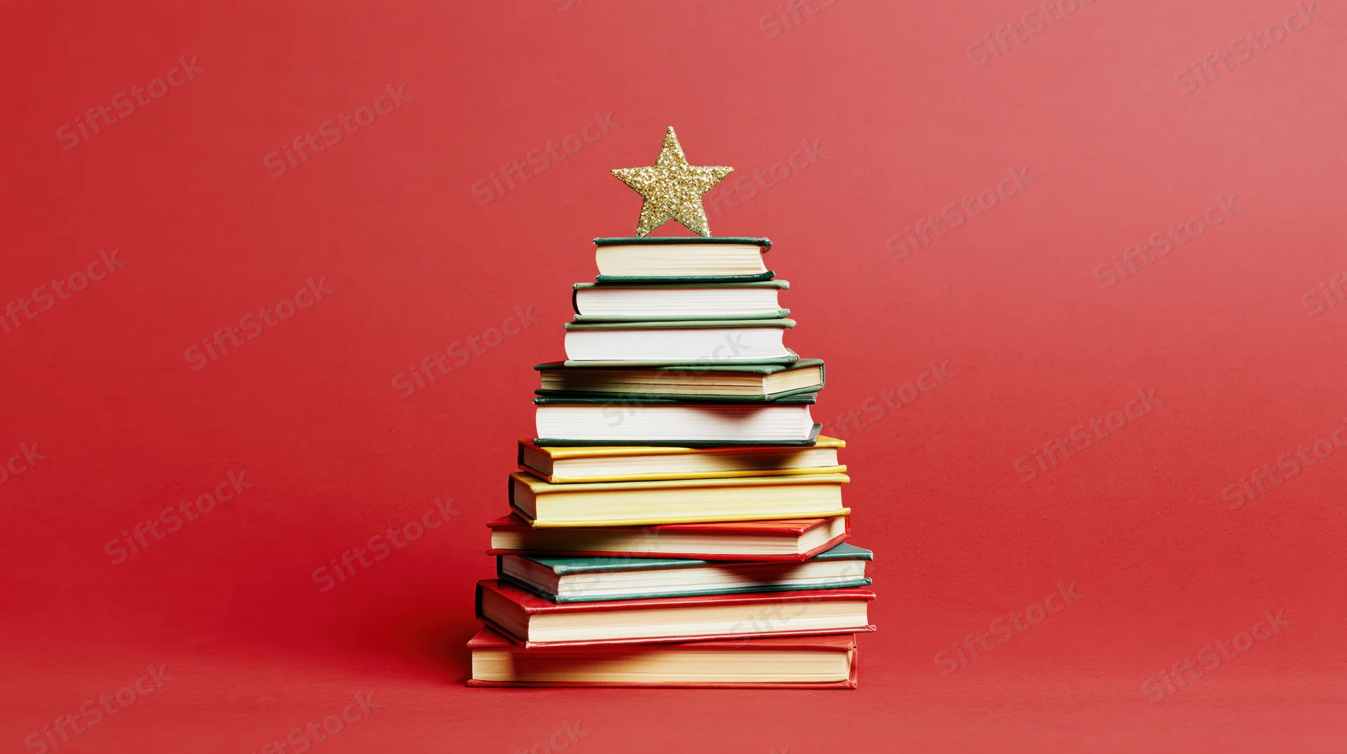 Stack of colorful hardcover books arranged in triangle shape with gold star on red background