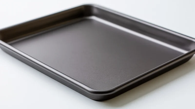 Dark grey nonstick baking sheet pan on white background