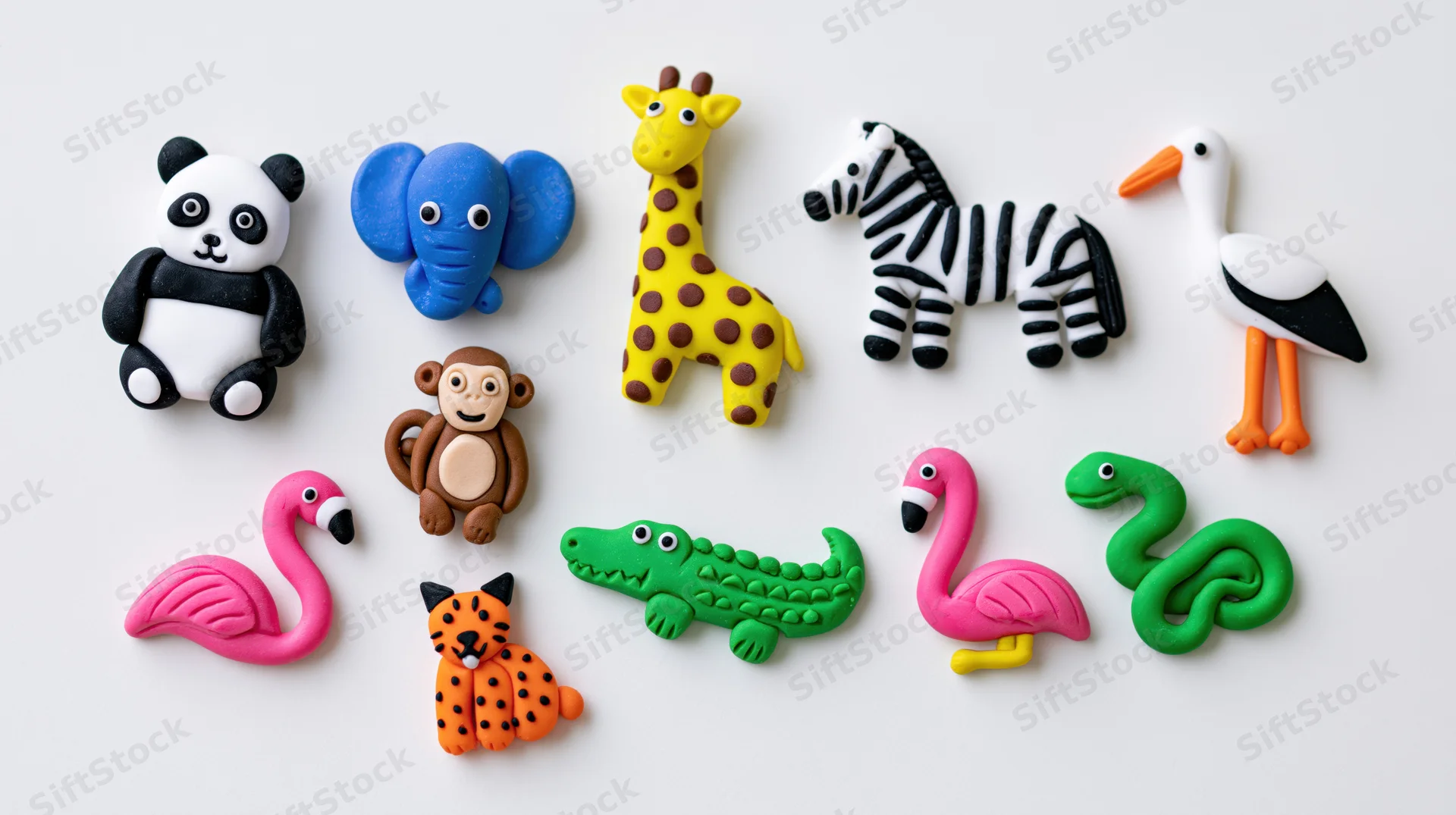 Colorful clay animal figurines arranged in a flat lay on white background