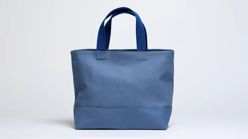Blue canvas tote bag with dual handles centered on white background