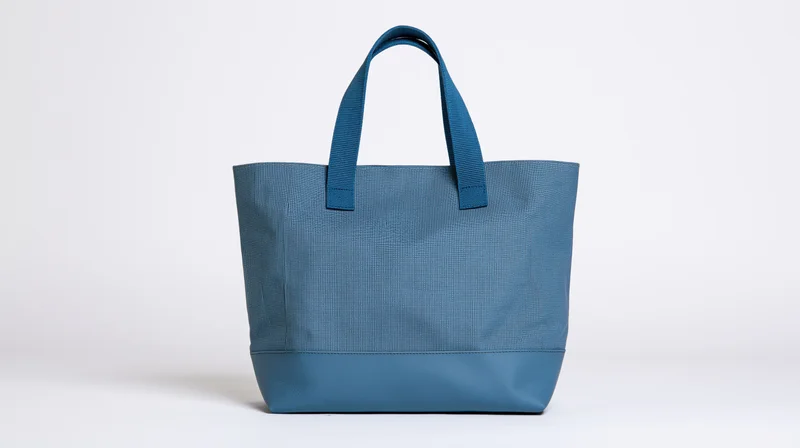 Blue canvas tote bag with dual handles centered on white background
