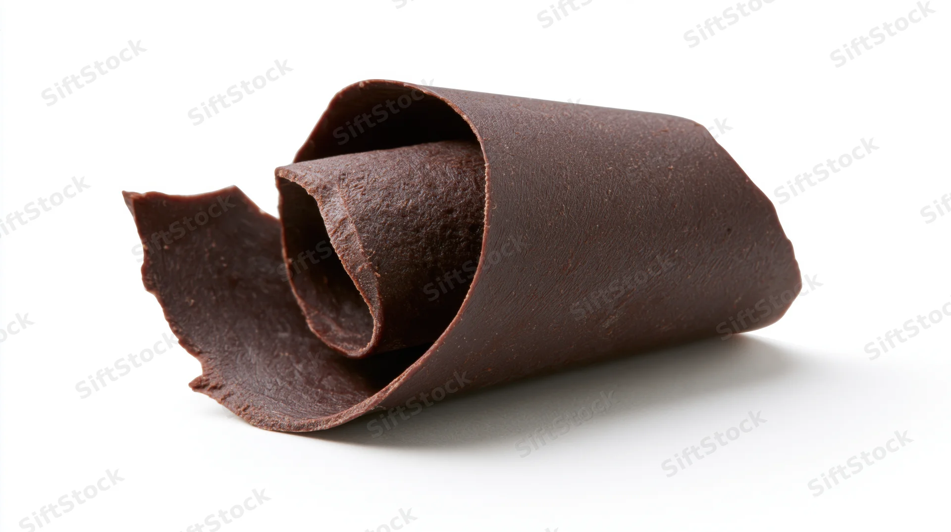 Dark chocolate curl shaving resting on white background