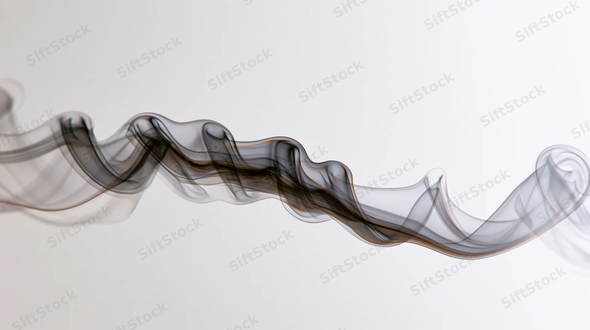 A wisp of dark gray smoke drifting horizontally across a plain background