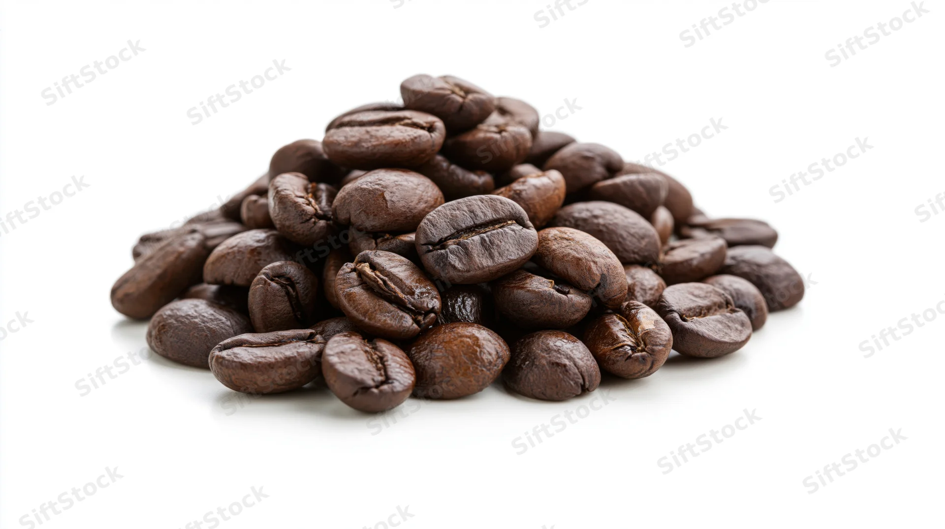 Small pile of dark roasted coffee beans heaped together on white background