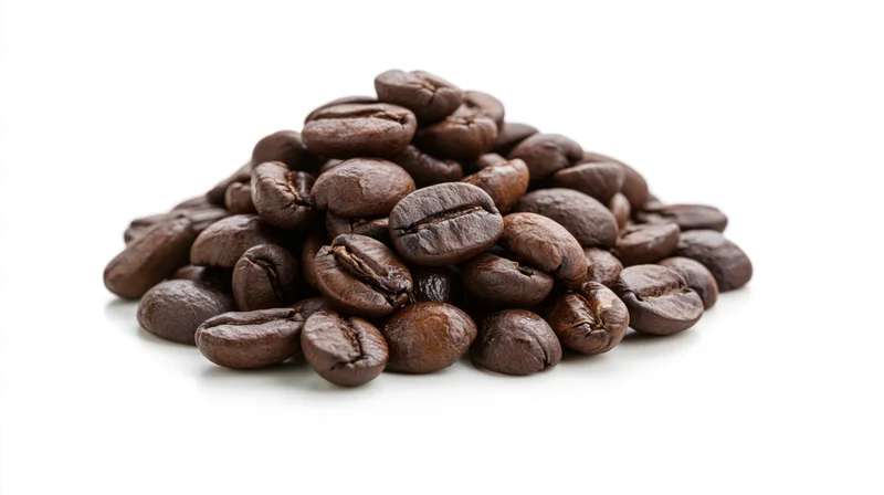 Small pile of dark roasted coffee beans heaped together on white background